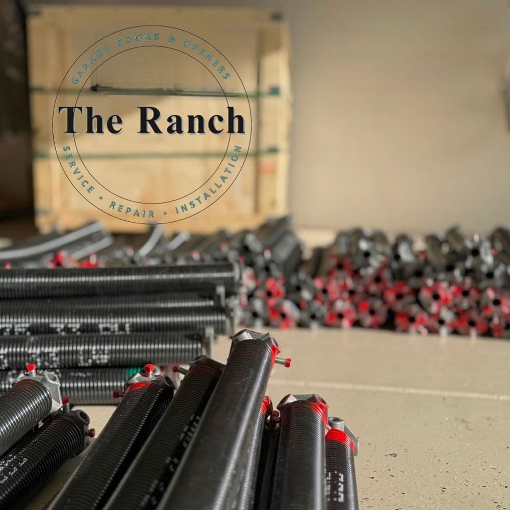 Coiled garage door springs in a service area, highlighting The Ranch's repair and installation.
