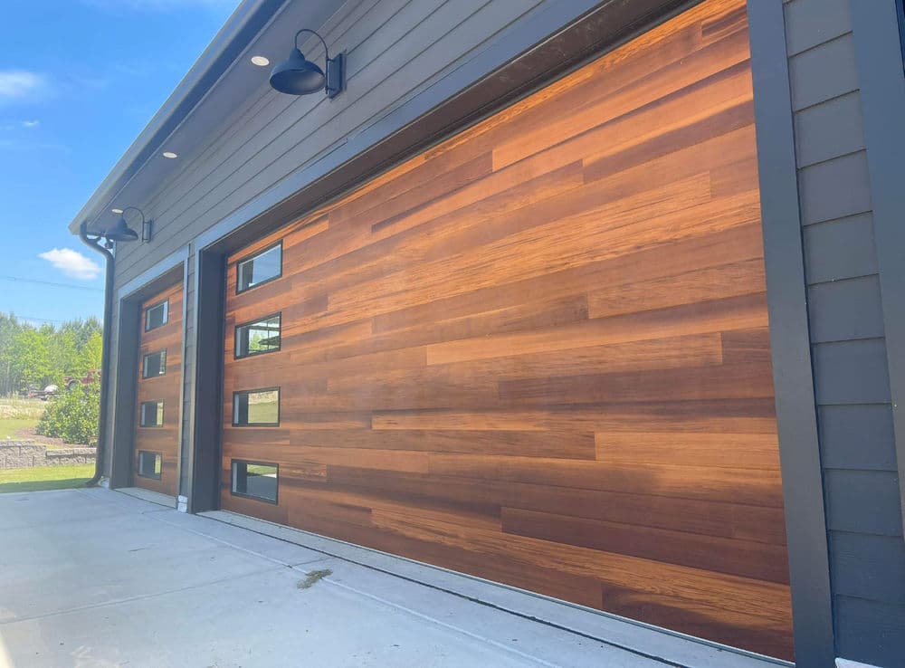 Modern wooden garage door with sleek design and windows, enhancing curb appeal.